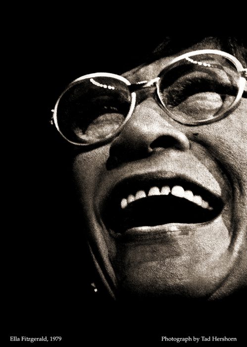 close up photograph of an older woman with glasses laughing
