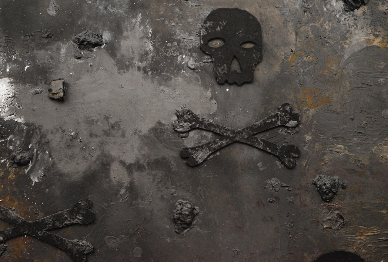 Heavily textured painting in blacks and grays of a skull and crossbones