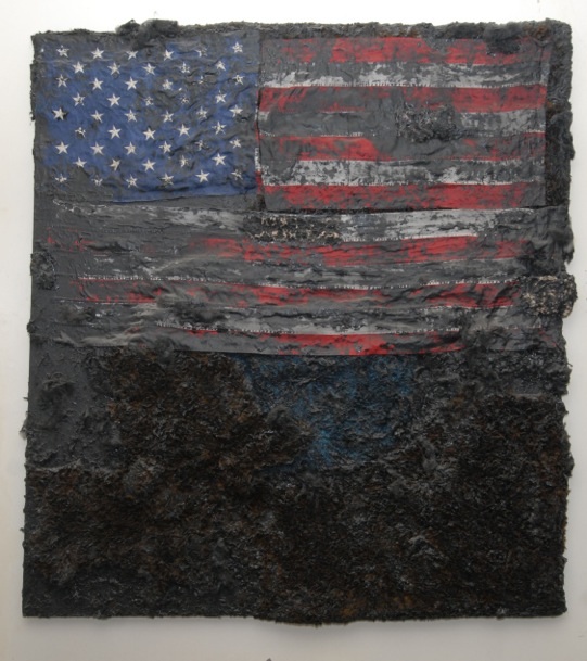 A painting of an American flag, barely visible because it is painted over in black