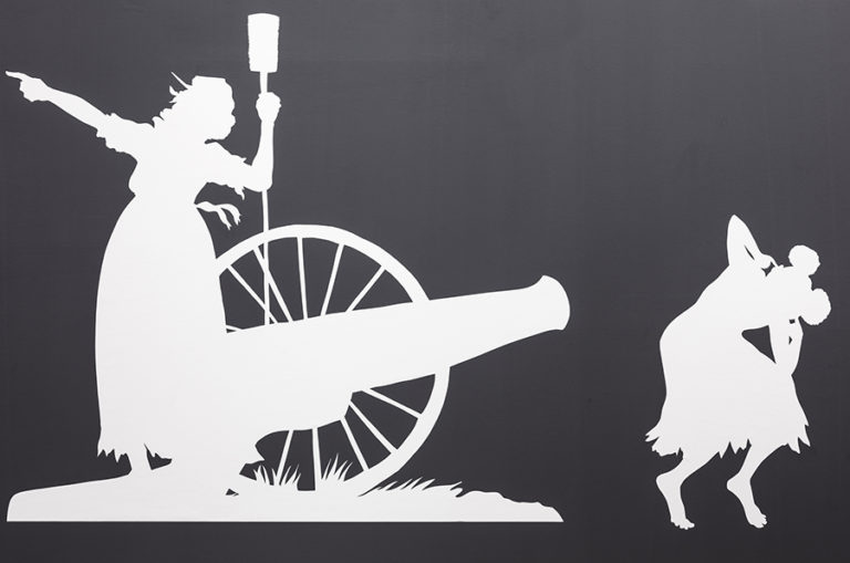 Shilhouets of two people: on crouching in front of a cannon, one standing and pointing away.
